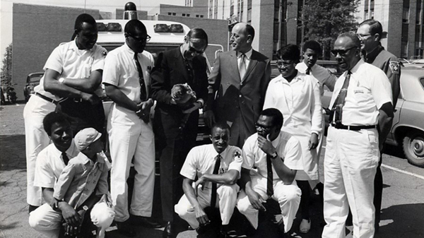 Group of Freedom House employees along with founder Phil Hallen outside Pittsburgh's Presbyterian Hospital. 1967-1968 (source: John Moon)